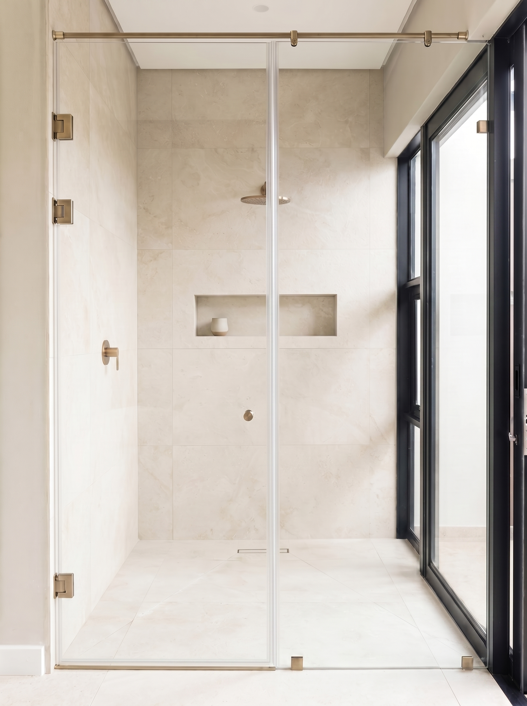 Frameless shower enclosure